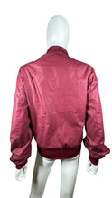 Load image into Gallery viewer, Revamp your wardrobe with the Vintage Members Only Maroon Jacket! This zip up jacket features a unique two button collar that adds a touch of sophistication and charm. Plus, its flattering measurements of 41&quot; flat chest, 24&quot; sleeves, and 25&quot; length wil...
