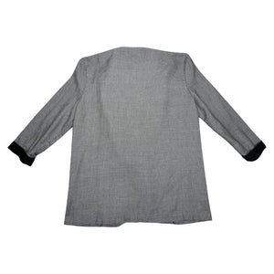 Experience the timeless style and sophistication of the Vintage Marnie Houndstooth 80s Blazer. This stunning black and white blazer features two front pockets, a single front button, and stylish black cuffs on the sleeves. With a measured flat chest of...
