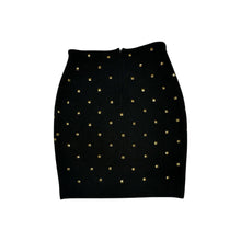 Load image into Gallery viewer, This is a Vintage Outlander Collection Skirt from the 80&#39;s thats a high waisted black skirt with metal gold studs all over that zips in the back. Measured Flat Waist - 28&quot; Hips - 36&quot; Length - 21&quot;
