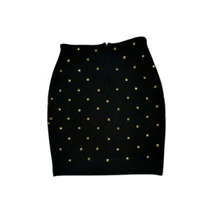 This is a Vintage Outlander Collection Skirt from the 80's thats a high waisted black skirt with metal gold studs all over that zips in the back. Measured Flat Waist - 28" Hips - 36" Length - 21"