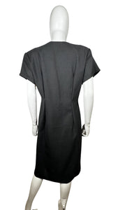 The Vintage 80's Rare Find David Mitchell Dress boasts a black hue and bold, vibrant oversized buttons. With measurements of Chest - 35", Hips - 34", and Length - 43", this dress offers a fun and unique twist to the classic little black dress.