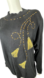 Experience the ultimate blend of style and comfort with our Vintage AfterShock Sweatshirt. This black long sleeve has been beautifully crafted with gold embellishment, embroidered tassels, and shoulder pads. Measured at 46" for the chest, 25" for the s...