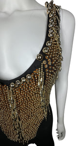 This Vintage Black and Gold Beaded Leotard has a stretchy and comfortable feel. Although it may show some wear and tear, it still holds its unique charm with a few holes and a missing bead on the chest. In the past, I had a skirt attached to the back t...
