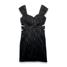 Load image into Gallery viewer, Black cocktail dress with cap sleeves, filagree pattern and cut outs on the sides. Measured Flat Chest - 34&quot; Waist - 30&quot; Hips - 34&quot; Length - 35 1/2&quot;