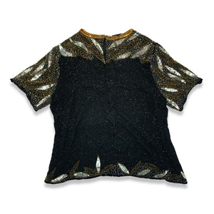 Get ready to shine with this Vintage Jennifer Joseph Lebon top that doubles as an oversized dress! The sequins and beads add a touch of glam, and it measures at a comfortable chest size of 46 inches with 11 1/2 inch sleeves and a 29 inch length.
