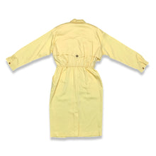Load image into Gallery viewer, This vintage yellow trench dress can do double duty as both a dress and an open trench coat. One of the buttons is currently M.I.A. at the very bottom, but it&#39;s still a standout piece. When lying flat, it measures 22 inches for the sleeve, 32 inches fo...