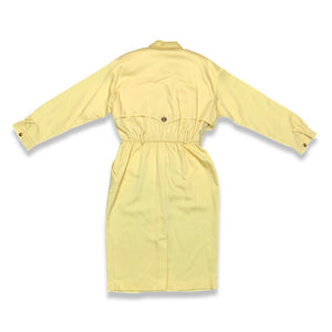 This vintage yellow trench dress can do double duty as both a dress and an open trench coat. One of the buttons is currently M.I.A. at the very bottom, but it's still a standout piece. When lying flat, it measures 22 inches for the sleeve, 32 inches fo...