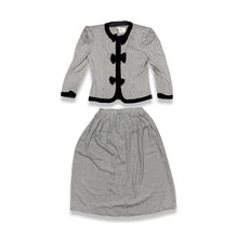 Load image into Gallery viewer, This posh Vintage Jessica Howard by Mitchell Rodbell suit features a charming houndstooth blazer with shoulder pads and a matching skirt. Measurements when laid out flat include 32&quot; for the top chest and 21&quot; for the sleeves, with a length of 23&quot;. The b...