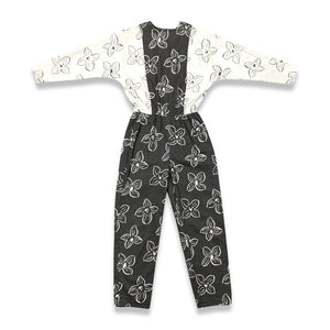 Introducing a one-of-a-kind black and white floral jumpsuit from the 80's, complete with a stretch waist for ultimate comfort. Measurements include: Chest - 39", Sleeve - 24", Waist - 26", Hips - 40", Inseam - 28", Length - 60". Don't miss this rare vi...