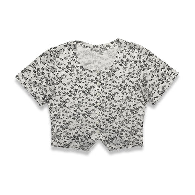 Experience a touch of nostalgia with our Vintage Black and White Floral Crop Top - the perfect blend of old and new. This short sleeve button-up piece features a chest measurement of 34